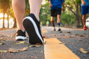 close up view of walkers feet walking down paved road